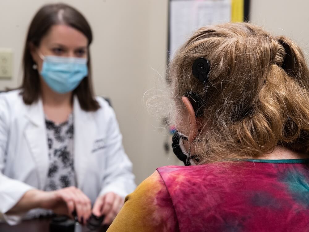 Cochlear implants doctor with a patient during consultation